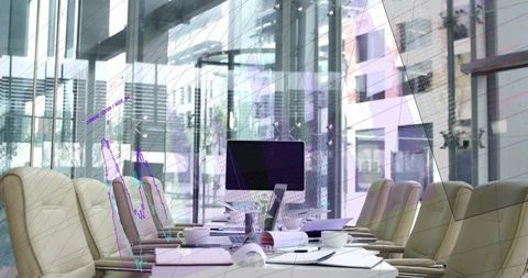 Modern glass boardroom with long white conference table, desktop monitor and blueprints