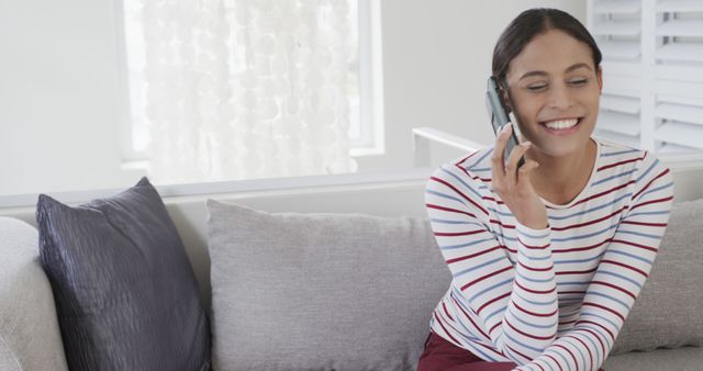 Smiling Woman Having Phone Conversation on Couch at Home - Download Free Stock Images Pikwizard.com