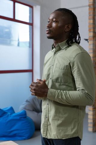 Professional Man Contemplative in Office Lounge Setting