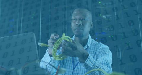 Server technician managing network cables in server room