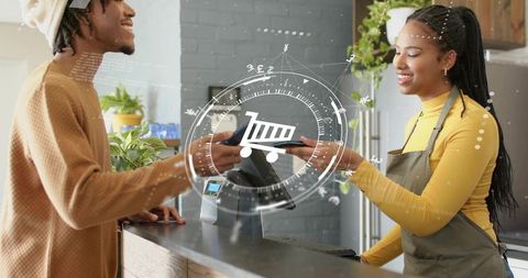 Smiling retail clerk taking contactless payment at counter with greenery and POS overlay