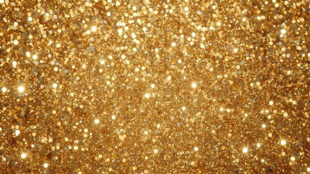 Glittering Gold Particles on Sparkling Abstract Background