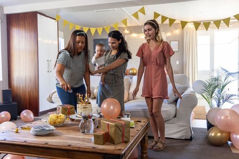 Family Celebration in Cozy Living Room with Cake