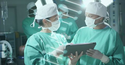 Surgeons Analyzing Data with Tablet in Operating Room