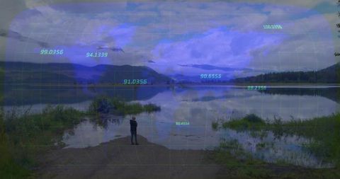 Woman standing lakeshore using augmented reality overlay for environmental lake mapping
