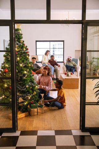 Diverse Family Decorating Christmas Tree with Cozy Winter Atmosphere