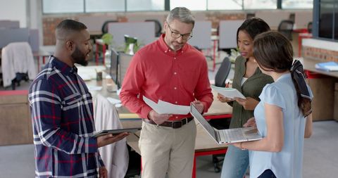 Diverse Team Collaborating on Project in Modern Office Space