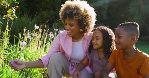 Family Time in the Garden: Mother and Children Discovering Blossoms