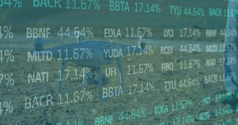 Hovering consumer drone displaying teal data overlay over field with operator in jeans