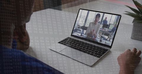Remote team video call on laptop with code overlay, woman watching from home workspace