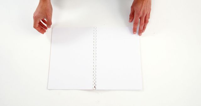 Hands Placing White Spiral Notebook on Blank Surface - Download Free Stock Images Pikwizard.com