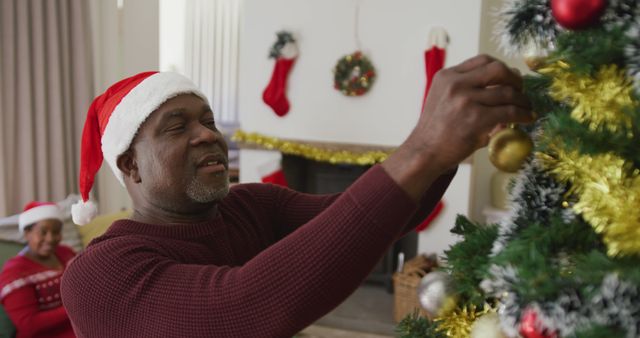 Happy Senior Man Decorating Christmas Tree in Festive Living Room - Download Free Stock Images Pikwizard.com