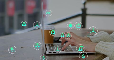 Hands Typing on Laptop with Eco and Technology Icons Overlay
