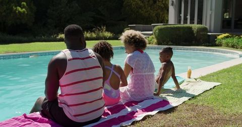 Family Enjoying Sunny Day by Backyard Poolside