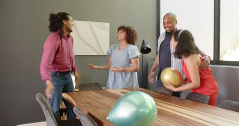 Diverse Friends Gather for Joyful Celebration in Modern Living Room
