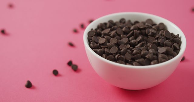 Image of bowl of chocolate chip over pink background - Download Free Stock Photos Pikwizard.com
