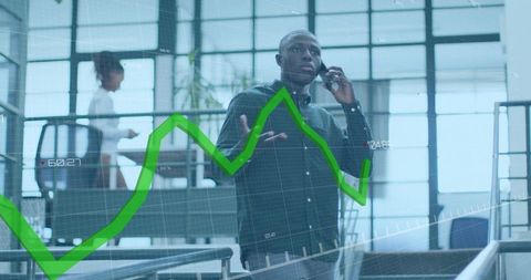 Businessman talking on phone in modern office with rising green analytics chart overlay