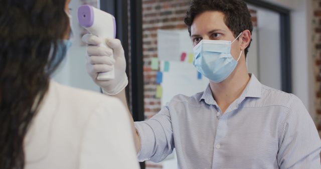 Healthcare professional using infrared thermometer during COVID-19 - Download Free Stock Images Pikwizard.com