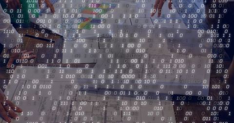 Collaborating over blueprints with binary overlay representing digital integration
