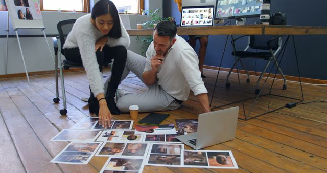 Creative Team Collaborating on Photo Selection in Office - Download Free Stock Images Pikwizard.com