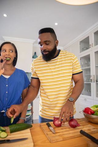 African American Couple Preparing Vegetables in Modern Kitchen
