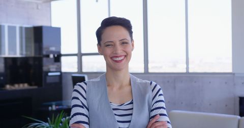 Happy Female Executive in Modern Office with Arms Crossed - Download Free Stock Images Pikwizard.com