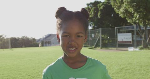 Joyful Girl Wearing Recycling T-shirt at Park on Sunny Day