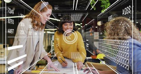 Diverse team collaborating over architectural plans with augmented reality interfaces