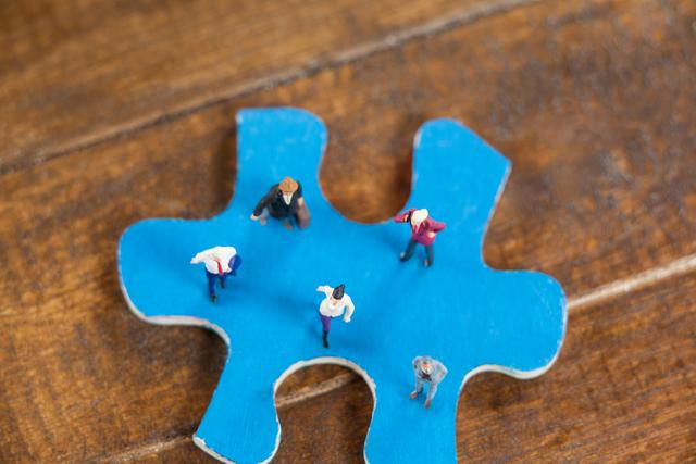 Miniature People on Blue Jigsaw Puzzle Piece - Download Free Stock Photos Pikwizard.com