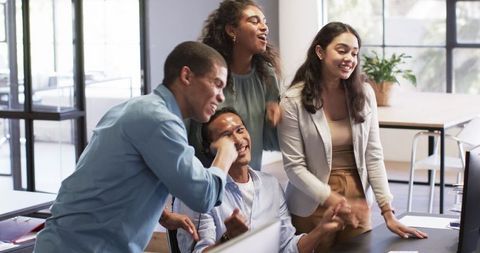 Creative Team Celebrating Successful Project in Modern Office