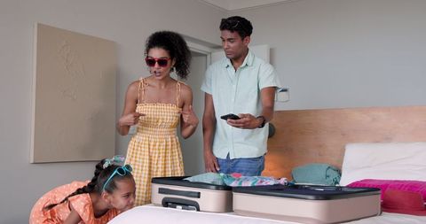 Family Packing Suitcase and Taking Selfie for Vacation Enjoyment