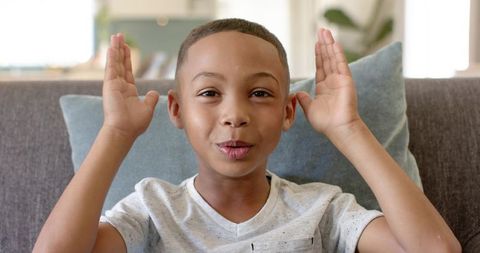 Cheerful African American Boy Chatting at Home