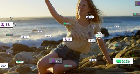 Young woman on rocky shore with social media engagement overlays at golden hour coastline