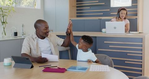 Father Supporting Child with Homework Enthusiastically