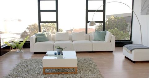 Elegant minimalist living room with white sectional and modern decor