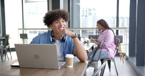 Smiling Man With Laptop and Coffee in Modern Cafe - Download Free Stock Images Pikwizard.com