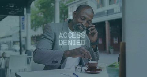 Professional executive multitasking in outdoor urban cafe setting