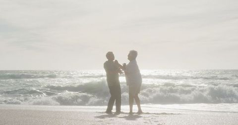 Romantic Hispanic Senior Couple Dancing on Beach at Sunset - Download Free Stock Images Pikwizard.com