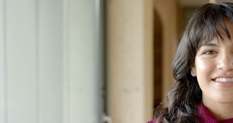 Asian Woman in Burgundy Sweater by Window