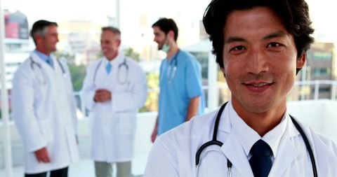 Confident Doctor Leading Medical Team at Hospital