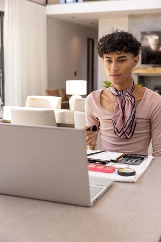 Asian Man Engaging in Makeup Routine at Home with Modern Setting