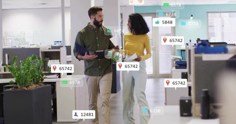 Colleagues walking and discussing with floating analytics overlays in open-plan office