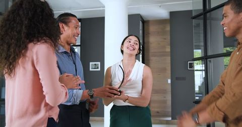 Team Celebrating Success with Enthusiastic Applause in Office