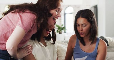 Excited Friends Sharing News of Pregnancy at Home