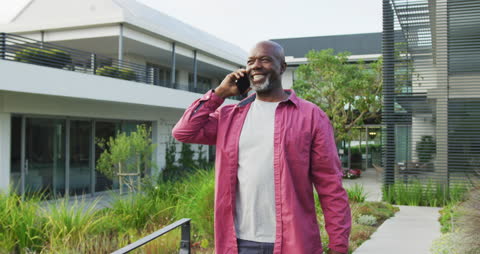 Senior Enjoying Leisure Time on Walk Using Smartphone