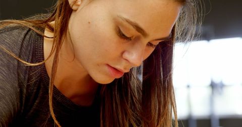 Caucasian Woman Preparing for Workout in Fitness Studio