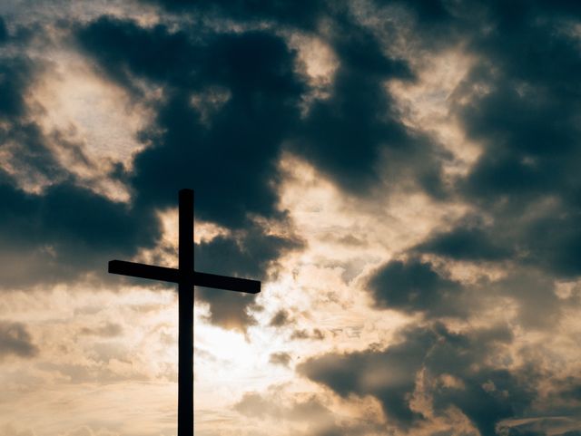 Silhouette of Cross Against Dramatic Cloudy Sky - Download Free Stock Photos Pikwizard.com