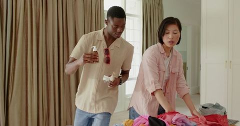 Couple preparing clothes for travel at home