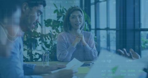 Multiethnic team discussing financial data in modern office setting