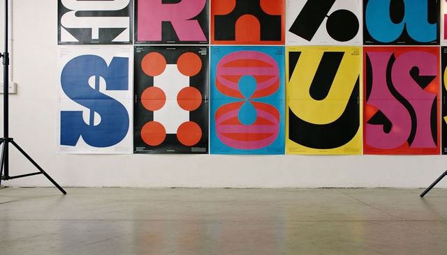 Bold geometric poster grid in minimal studio featuring vibrant color blocks and tripods